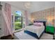 Bright bedroom with vaulted ceiling, large window, statement wallpaper, and stylish decor at 17924 River Ford Dr, Davidson, NC 28036