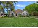 Charming one-story home has a brick exterior, manicured lawn and established landscaping at 17924 River Ford Dr, Davidson, NC 28036