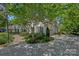 Beautifully landscaped home exterior with a circular driveway and lush greenery at 17924 River Ford Dr, Davidson, NC 28036
