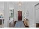 Welcoming foyer features a wood front door, hardwood floors, elegant lighting and millwork at 17924 River Ford Dr, Davidson, NC 28036