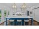 Bright kitchen features a large island with marble countertops, custom cabinets and gold light fixtures at 17924 River Ford Dr, Davidson, NC 28036