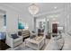 Stately living room featuring an open floor plan, elegant chandelier, and views into the dining area at 17924 River Ford Dr, Davidson, NC 28036
