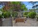 Beautiful outdoor stone fireplace has seating, custom pergola, and is surrounded by lush landscaping at 17924 River Ford Dr, Davidson, NC 28036