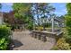 Inviting outdoor kitchen has stone countertops, bar seating, grill and fireplace for outdoor entertaining at 17924 River Ford Dr, Davidson, NC 28036