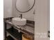Modern half-bathroom with vessel sink, black hardware, and marble counter at 1816 Lisbon Ln, Charlotte, NC 28269