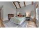 Bedroom with vaulted ceiling, wooden beams, and neutral decor at 1816 Lisbon Ln, Charlotte, NC 28269