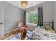 Cozy bedroom featuring a comfortable bed, soft lighting, and peaceful view of backyard at 1816 Lisbon Ln, Charlotte, NC 28269