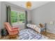 Charming bedroom features a cozy reading nook and views of the yard at 1816 Lisbon Ln, Charlotte, NC 28269