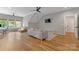 Large bonus room featuring a comfortable gray couch, modern desk, and hardwood flooring at 1816 Lisbon Ln, Charlotte, NC 28269
