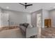 Versatile bonus room with a cozy gray couch, hardwood floors, and access to an ensuite bathroom at 1816 Lisbon Ln, Charlotte, NC 28269