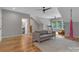 Spacious bonus room with a gray couch, hardwood floors, and natural light from multiple windows at 1816 Lisbon Ln, Charlotte, NC 28269