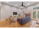Bright and airy living room with a fireplace, hardwood floors, and a large window at 1816 Lisbon Ln, Charlotte, NC 28269