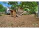 Backyard playground featuring a trampoline, a treehouse, and a swing set on a wooded lot at 1816 Lisbon Ln, Charlotte, NC 28269