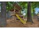 Backyard treehouse and playground with a slide, perfect for outdoor adventures at 1816 Lisbon Ln, Charlotte, NC 28269