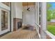 Inviting screened porch featuring a brick fireplace, wood floors, and views of the lush backyard at 1816 Lisbon Ln, Charlotte, NC 28269
