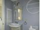 Charming bathroom features vintage-style sink, fixtures, and shelving for added appeal at 1820 Trinity Church Rd, Monroe, NC 28112