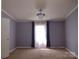 Spacious bedroom with soft carpet, large windows, and elegant lighting fixtures at 1820 Trinity Church Rd, Monroe, NC 28112