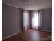 Inviting bedroom featuring wood-look flooring and soft, diffused natural light at 1820 Trinity Church Rd, Monroe, NC 28112