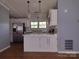 Bright kitchen featuring white cabinets, stainless steel appliances, and a modern countertop at 1820 Trinity Church Rd, Monroe, NC 28112