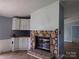 Cozy living room with a stone fireplace and white cabinets, perfect for relaxing and entertaining guests at 1820 Trinity Church Rd, Monroe, NC 28112