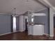 Open-concept living and dining area with a decorative chandelier and neutral paint at 1820 Trinity Church Rd, Monroe, NC 28112