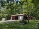 Outbuilding with gravel driveway; perfect for storage or workshop at 1820 Trinity Church Rd, Monroe, NC 28112