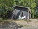 Outbuilding featuring custom horse and carriage motif and gravel parking area at 1820 Trinity Church Rd, Monroe, NC 28112