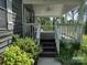 Covered porch with white railing and staircase leading to the home's entrance at 1820 Trinity Church Rd, Monroe, NC 28112