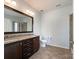 Bathroom featuring a double sink vanity with granite countertops and tile flooring at 1876 Yellow Daisy Dr, Matthews, NC 28104