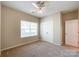 A cozy bedroom featuring a ceiling fan, natural light, and a double-door closet for ample storage at 1876 Yellow Daisy Dr, Matthews, NC 28104
