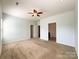 Large bedroom with a ceiling fan, carpeted flooring, neutral walls and access to bathroom at 1876 Yellow Daisy Dr, Matthews, NC 28104