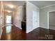 A bright entryway with hardwood floors features a storage closet and a bar with granite countertop at 1876 Yellow Daisy Dr, Matthews, NC 28104