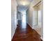Hallway with hardwood flooring connects various rooms, promoting an open and flowing layout at 1876 Yellow Daisy Dr, Matthews, NC 28104