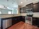 Kitchen features stainless steel appliances, granite countertops, hardwood flooring and a breakfast bar at 1876 Yellow Daisy Dr, Matthews, NC 28104