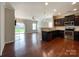 Living room with hardwood flooring that goes into the kitchen with stainless steel appliances at 1876 Yellow Daisy Dr, Matthews, NC 28104
