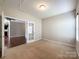 Bright living room with neutral walls, and French doors leading into an adjacent room at 1876 Yellow Daisy Dr, Matthews, NC 28104