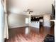 Open floor plan of living room that leads to kitchen, ceiling fan, with hardwood flooring at 1876 Yellow Daisy Dr, Matthews, NC 28104