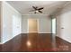 Open living room with hardwood floors, crown molding, and double closets for additional storage at 1876 Yellow Daisy Dr, Matthews, NC 28104