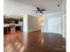 Spacious living room with hardwood floors, with a view into kitchen, creating an open and inviting atmosphere at 1876 Yellow Daisy Dr, Matthews, NC 28104