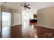 Spacious living room with hardwood floors, offering a view into the kitchen at 1876 Yellow Daisy Dr, Matthews, NC 28104