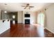 Spacious living room featuring a fireplace, ceiling fan, and hardwood flooring at 1876 Yellow Daisy Dr, Matthews, NC 28104