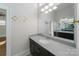 Bright bathroom featuring a large mirror over a vanity with dark cabinets and light countertop at 1909 Summey Ave, Charlotte, NC 28205