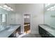 Elegant bathroom with dual vanities, modern fixtures, and a view into the light-filled bedroom at 1909 Summey Ave, Charlotte, NC 28205