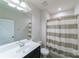 Bathroom featuring a toilet, striped shower curtain, black vanity, and updated fixtures at 1909 Summey Ave, Charlotte, NC 28205