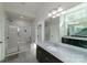 Modern bathroom with a walk-in glass shower, dual vanity and mirrors, offering a spa-like experience at 1909 Summey Ave, Charlotte, NC 28205