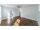 Sun-drenched bedroom featuring hardwood floors, a ceiling fan, and an en-suite bathroom at 1909 Summey Ave, Charlotte, NC 28205