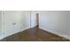 Bedroom featuring hardwood floors and a closet with modern paneled doors at 1909 Summey Ave, Charlotte, NC 28205