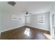 Bright bedroom with beautiful hardwood floors, white walls, and natural light from the windows at 1909 Summey Ave, Charlotte, NC 28205