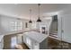 Kitchen with large center island, hardwood floors, a staircase, and lots of natural light at 1909 Summey Ave, Charlotte, NC 28205