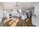 Open-concept living area featuring hardwood floors, fireplace, built-ins, island kitchen and plenty of light at 1909 Summey Ave, Charlotte, NC 28205